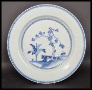 An 18th century Chinese Qing Long blue and white large plate hand painted depicting a blossoming