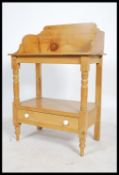 A Victorian pine country washstand being raised on turned legs having gallery top with washbowl