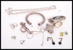 A collection of silver hallmarked and 925 costume jewellery to include a slave bangle set with