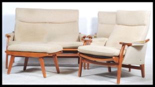 A retro 20th century Danish inspired three piece suite consisting of two armchairs and a matching