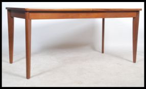 A 1960's retro teak wood Danish revival extending dining table of rectangular form being cross