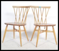 A pair of fantastic vintage  mid 20th Century Ercol Windsor beech and elm cross back candlestick