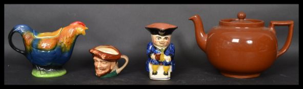 Four pieces of early to mid 20th century ceramics to include an over sized earthenware teapot from