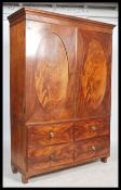 A late Victorian flame mahogany double wardrobe being raised on turned legs with oval panel doors