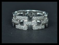 An 18ct white gold ring having interlocking sections of diamonds. Weighs 5 grams size P.