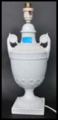 A 19th century Victorian style ceramic table lamp of urn form raised on a square base with