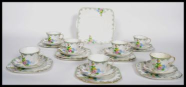 A 20th century Art Deco Bone China part tea service by Heathcote China having hand painted flower
