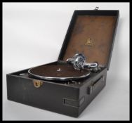 A vintage early 20th century portable gramaphone by Odeon. Set in the black carry case with deck and