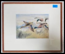 A 20th century handpainted lithograph print of flying mallards  and duck being signed by the