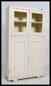 A vintage mid 20th century painted kitchen unit / cupboard, two glazed ( no glass ) doors to the top