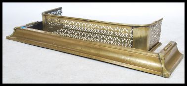 Two 19th century brass fire fenders. One of grille form having pierced decoration and the other of