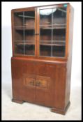 A 1930's Art Deco oak library bookcase cabinet. The glass display cabinet with shelved interior