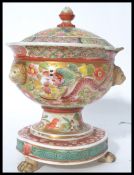A 19th century Chinese / Canton famille rose decorated tureen with lid. Raised on paw feet with a