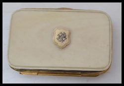 A vintage 19th century ivory and gilt metal purse with monogrammed armorial crest to front push