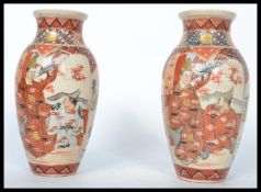 A pair of 19th century Japanese Satsuma vases, each of squat form having decorative scenes of