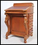 A Victorian style mahogany davenport writing desk. The gilt tooled leather desk top having appointed