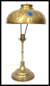 An early 20th century French brass table lamp having inset faceted purple stones to the shade.