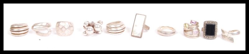 A dealers lot of silver to include 10 silver 925 rings. Brutalist, swirl, contemporary, stone set,