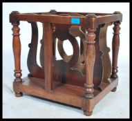 A Victorian walnut 19th century canterbury - magazine rack having pierced uprights with  plinth base