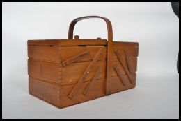 A 20th century retro mid century sewing box with sectional metamorphic interior complete with