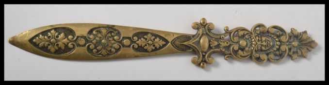 A 19th century French bronze brass paper knife letter opener having a pierced and scrolled