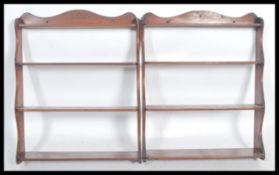 A pair of Victorian mahogany hanging wall shelves. Each with wavey shaped supports having central