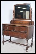 A 1920's Jacobean revival oak dressing chest of drawers. The chest with short and deep drawers