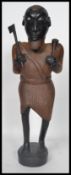 A 20th century large African Tribal carving figurine of a warrior holding an axe and club raised