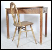 A vintage 20th century teachers school desk, single drawer to front with brass cup handle, raised on