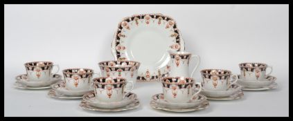 A late 19th / early 20th century bone china tea service in an Imari style pattern, consisting of