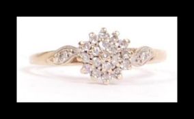 A hallmarked 9ct gold and diamond cluster ring set with a central cluster a single accent diamond
