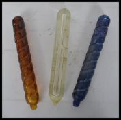 A group of three 19th century Victorian glass fire grenades / extinguishers.Two of twist coloured