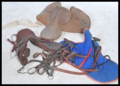 A collection of vintage 20th century horse racing equestrian items to include Jockey Silks , saddles
