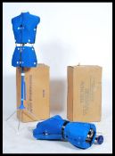 A pair of retro adjustable dress makers dummies, raised on tripod supports and retaining original
