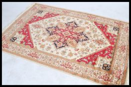 A large North Western Iranian / Persian Heriz carpet - rug having red and beige ground with