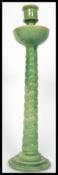 A 19th century Majolica candlestick in the manner of Minton's raised on a stepped circular base with