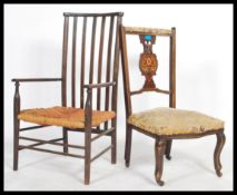 An early 20th century Arts & Crafts Macintosh revival nursing chairs with scrolled elbow rests