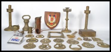 A collection of 19th and 20th century brass wares to include two pairs of candle sticks, horse