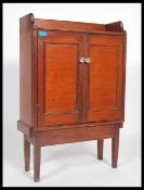 A 19th century Victorian shelved cabinet cupboard having a gallery back. Raised on square legs