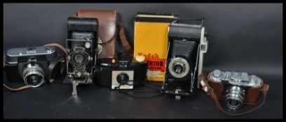 A collection of vintage 20th century cameras to include folding cameras. Model from Kodak,