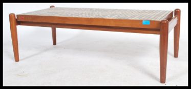 A vintage retro 1950's floating top teak wood coffee table having ceramic mosaic tiles set into