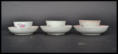 A group of three 18th century English famille rose tea bowls and saucers painted with pink ribbon