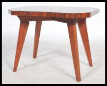 A vintage 20th century 1930s coffee / occasional table raised on splayed tapering legs with a