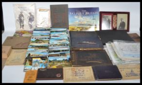 A large collection of ephemera to include postcards, photograph albums, cigarette cards, vintage