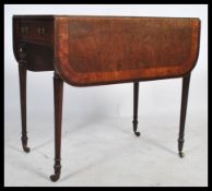 A 19th century Georgian mahogany and satinwood crossbanded pembroke table. Raised on turned legs