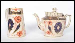 A 19th century Staffordshire teapot in the Imari pattern having a hinged ceramic lid atop together