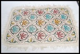 An early 20th century unusual believer Tibetan - inner asia raw lambs wood rug being decorated