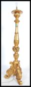A large ornate gilt standard lamp raised on moulde