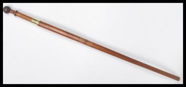 A vintage early 20th century walking stick cane having a hidden twist of section revealing a