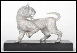 A 20th century silver plated Chinese figurine of a tiger raised on a plinth base. Measures 15 cm
